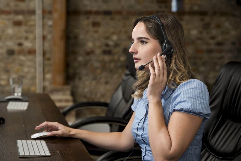 Professional working at a desk with headset, supporting ai search marketing strategy and digital customer communication