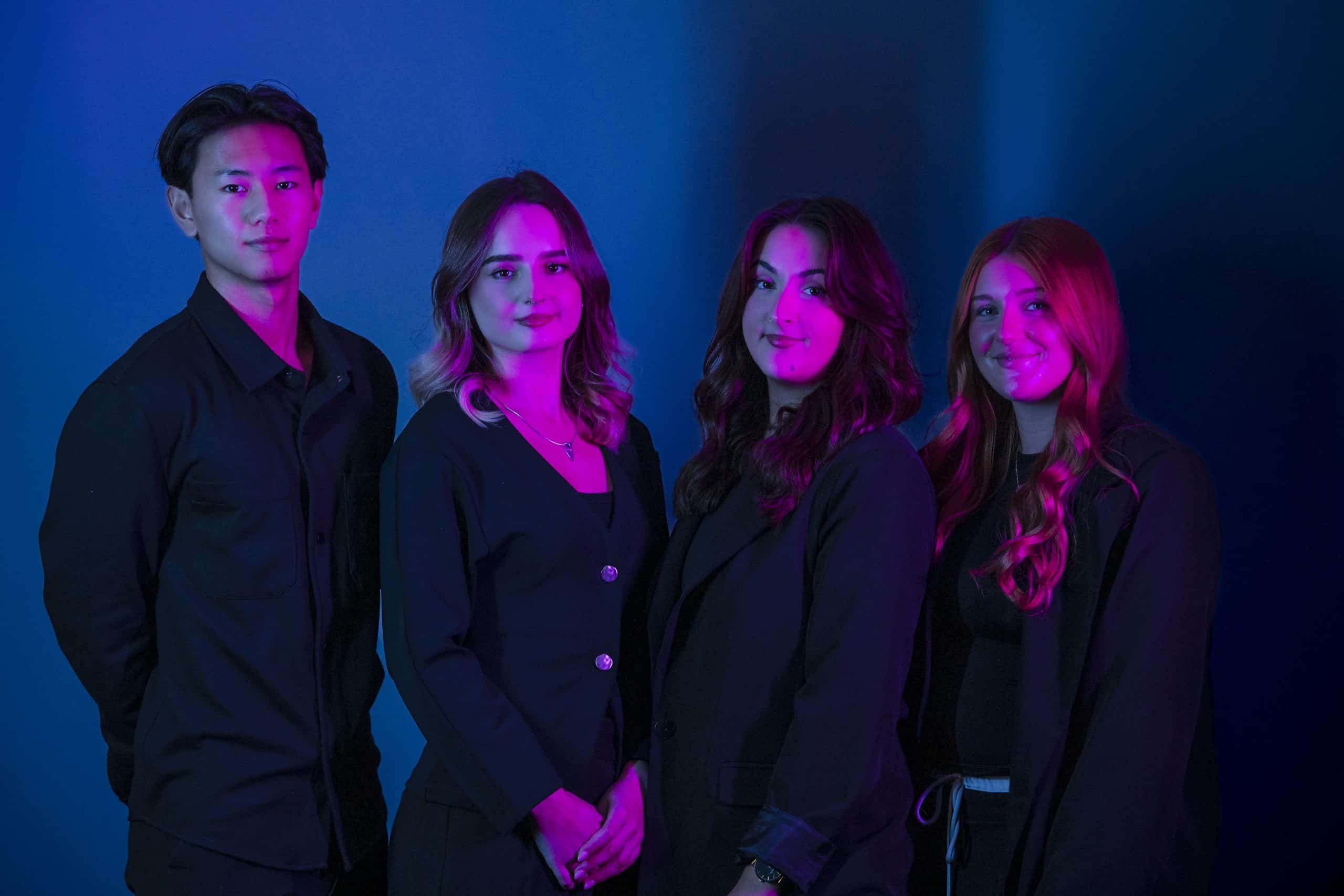 nu media group's SEO, web design and social media specialists photographed in studio under blue and purple lighting